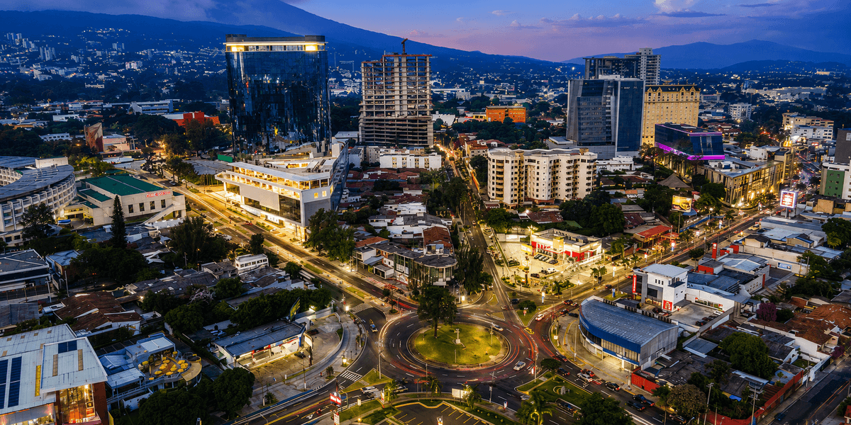Aerial view of San Salvador's Zona Rosa at sunset, showing the city's modernity